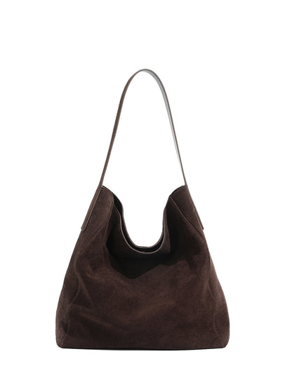 Front view of the ebony suede tote and its long shoulder strap