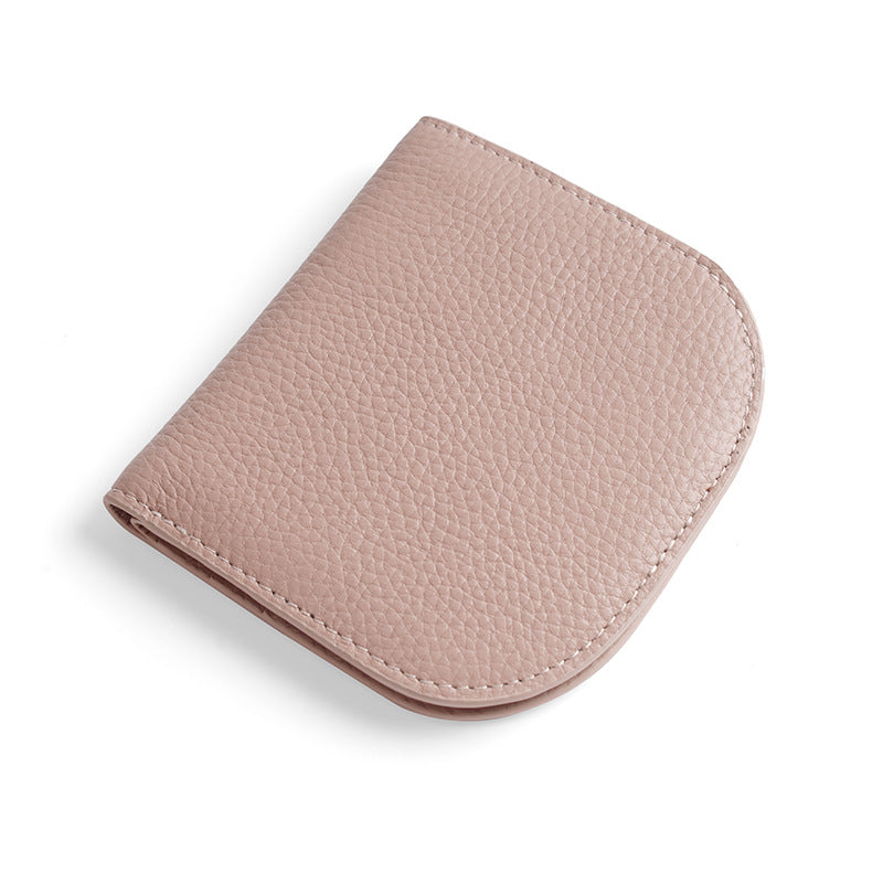 Light pink pebbled cowhide leather bifold wallet closed on white background