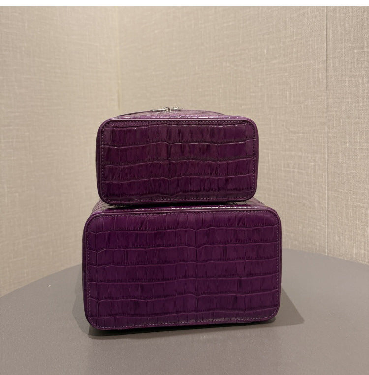 Purple cosmetic pouch pair shown with top handles and zip closures