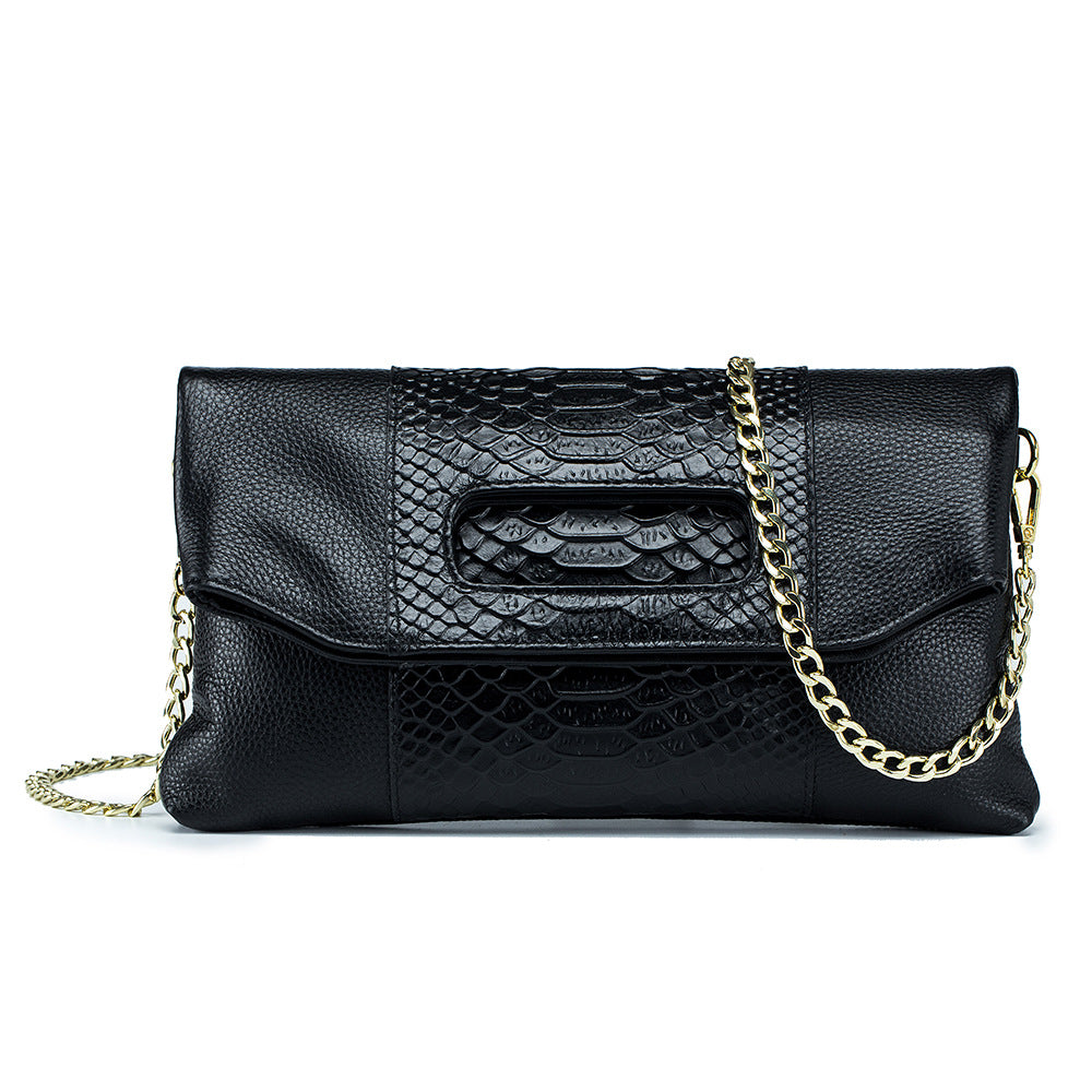 Black croc-embossed cowhide envelope clutch with gold-tone chain strap, front view