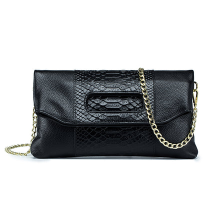 Black croc-embossed cowhide envelope clutch with gold-tone chain strap, front view