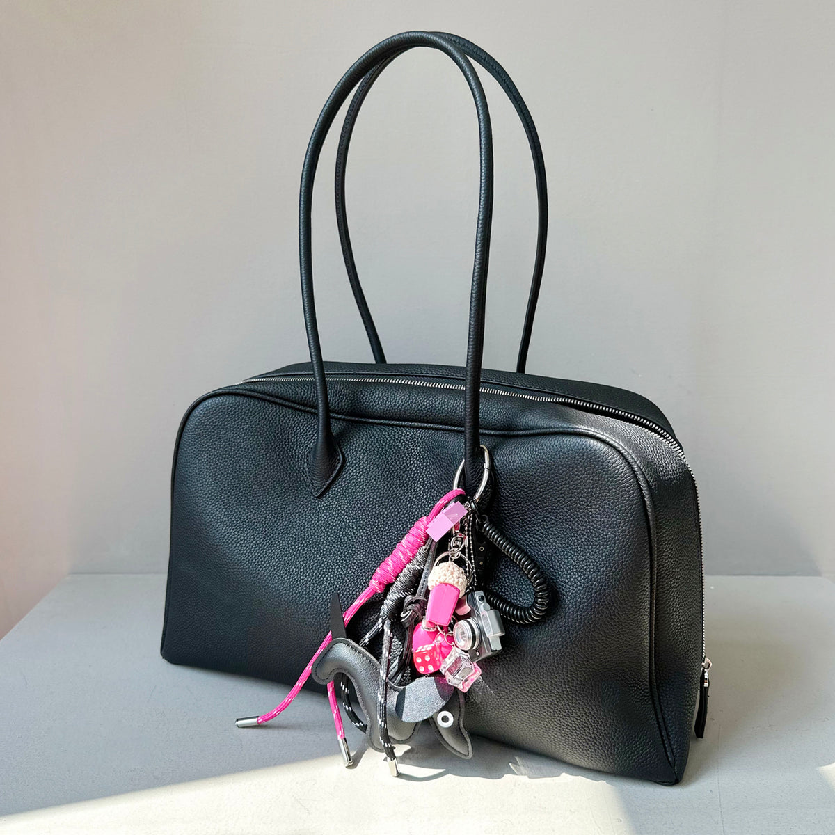 Close-up of black pebbled leather texture and bag zipper