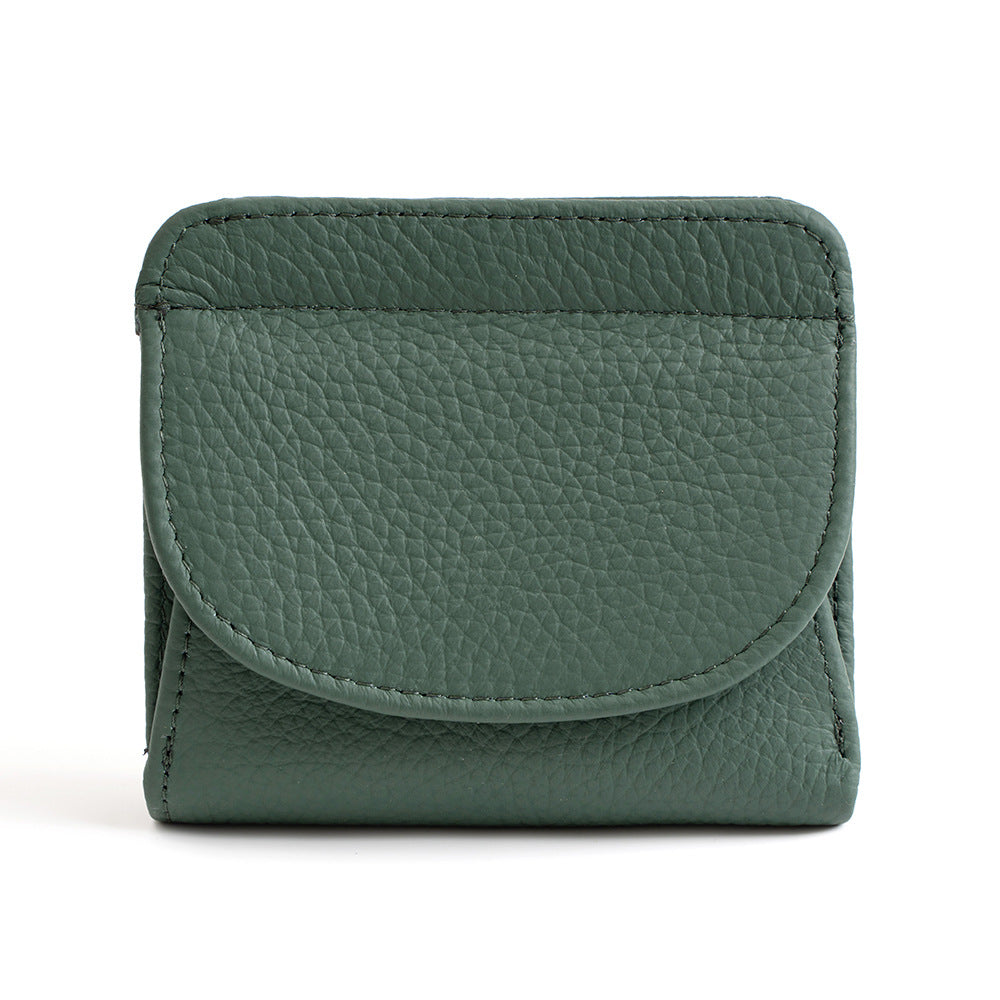 Genuine leather bifold wallet in jade green on white background