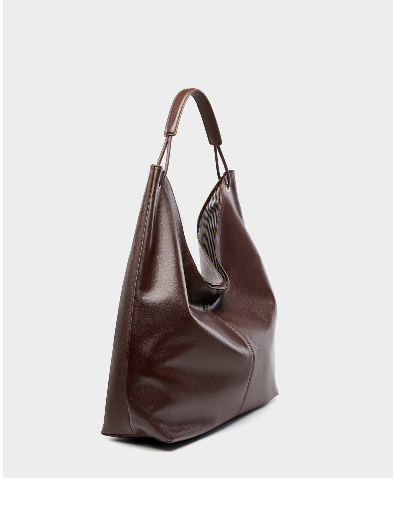 Dark brown hobo tote bag side view on light gray background