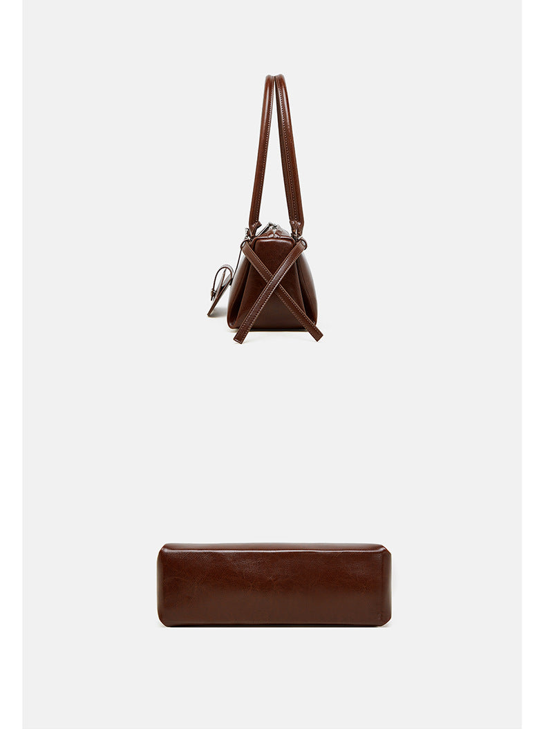Top-down and side view of brown leather barrel bag showing handle length and base depth