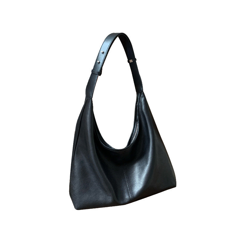 Black lambskin tote photographed against a plain background