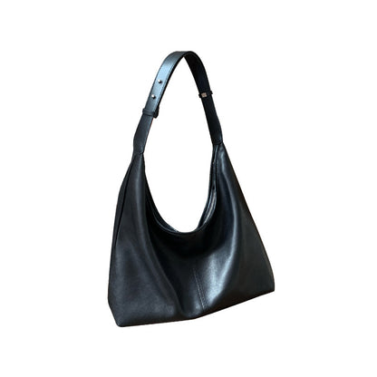 Black lambskin tote photographed against a plain background