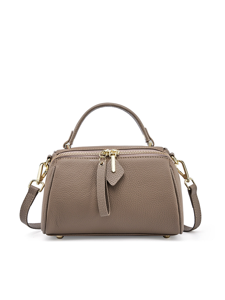 Gray mini Boston bag front view showing dual zip top and decorative leather pull