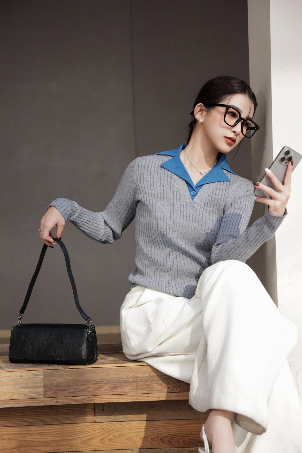 Crossbody view of the structured black flap bag