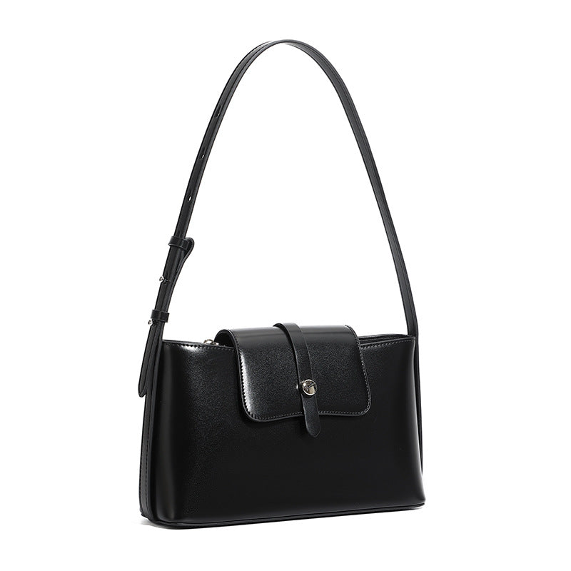 Black leather shoulder bag on white background