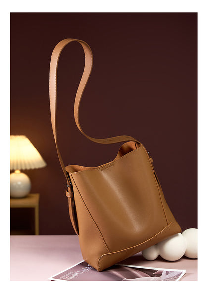 Golden Brown bucket bag standing upright on table