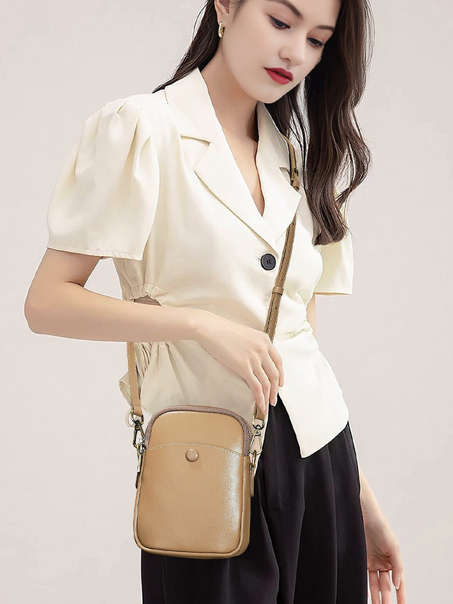 Model wearing apricot cowhide leather mini crossbody bag over the shoulder