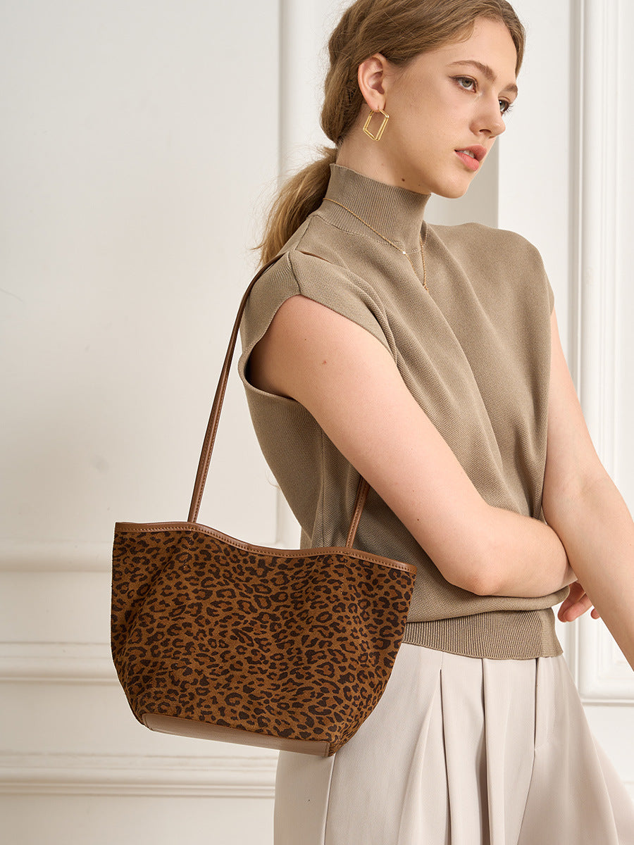 Leopard print bucket tote worn over the shoulder