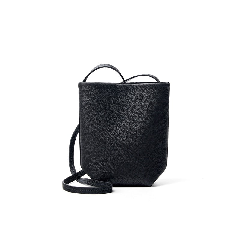 Black top-grain cowhide mini bucket crossbody bag on white background