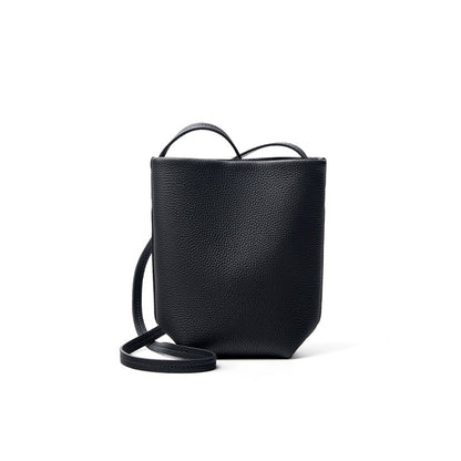 Black top-grain cowhide mini bucket crossbody bag on white background