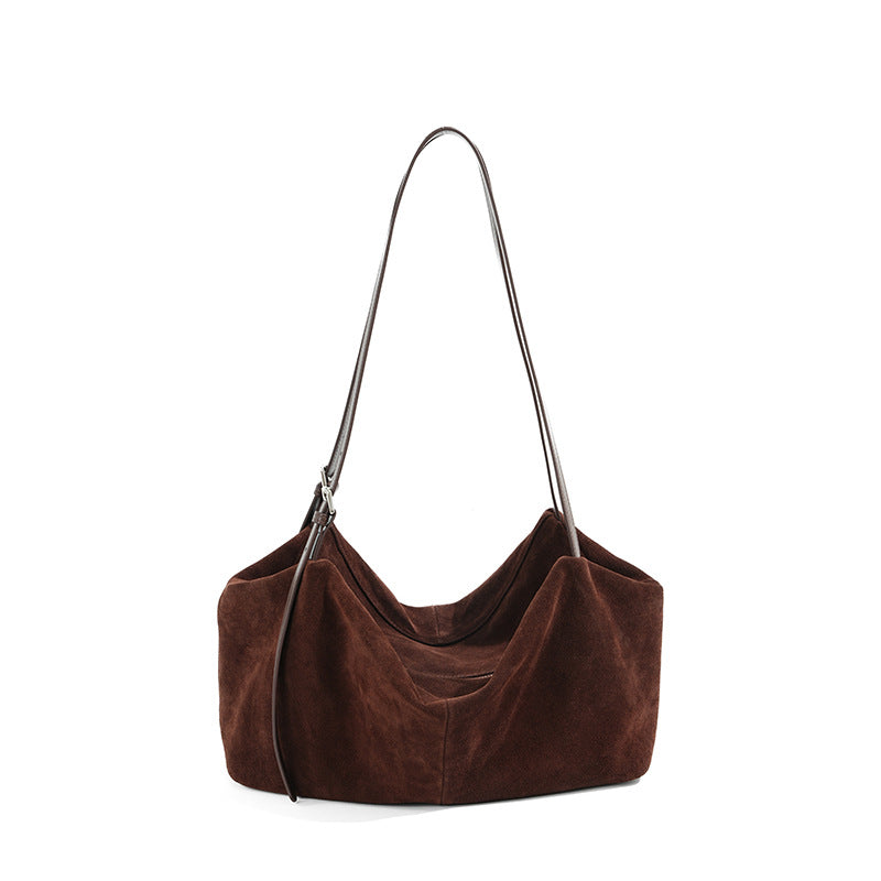 Coffee suede cowhide tote bag with long shoulder strap on white background
