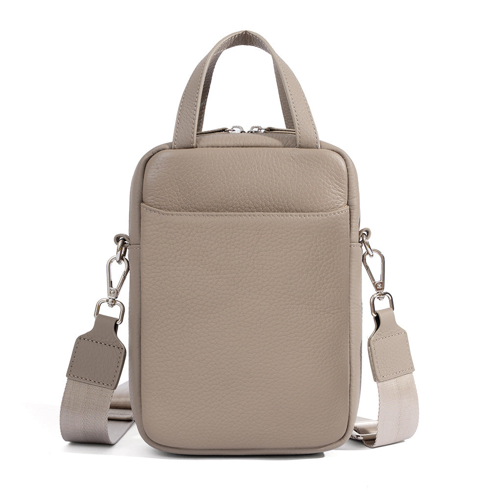 Light gray pebbled leather mini crossbody phone bag with detachable woven strap and top handles
