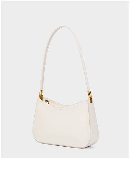 Cream shoulder bag standing upright with strap arched above