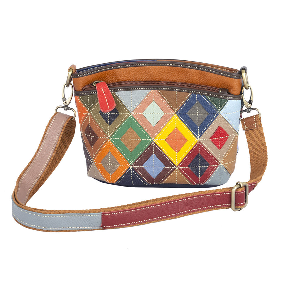Front view of a multicolor geometric patchwork cowhide crossbody bag
