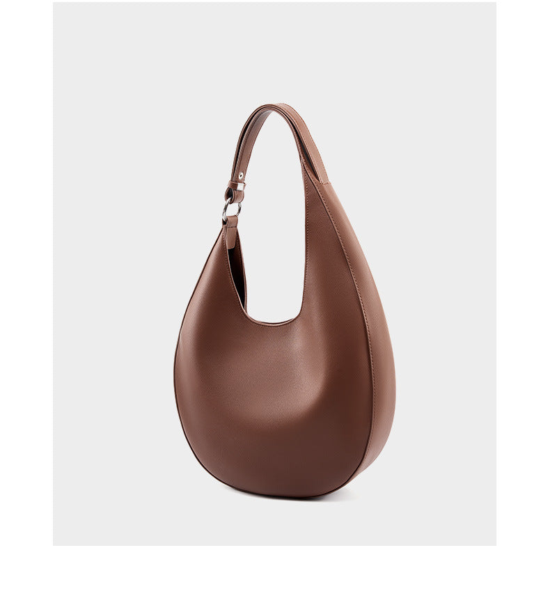 Dark brown cowhide crescent hobo bag three-quarter view on white background