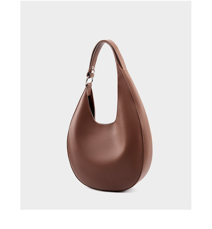 Dark brown cowhide crescent hobo bag three-quarter view on white background