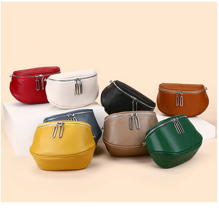 Multiple colors of saddle-style crossbody bag displayed together