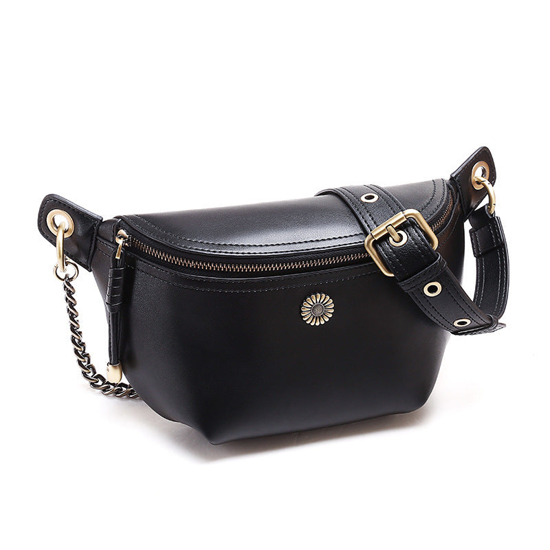 Front view of black split leather belt bag with decorative sunburst and zip closure