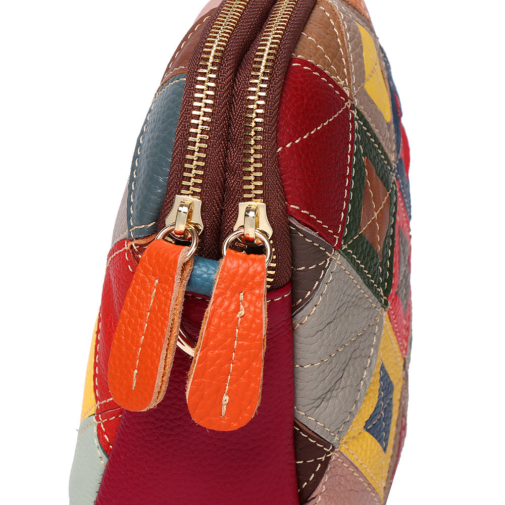 Close-up of colorful stitched leather panels and zipper pulls