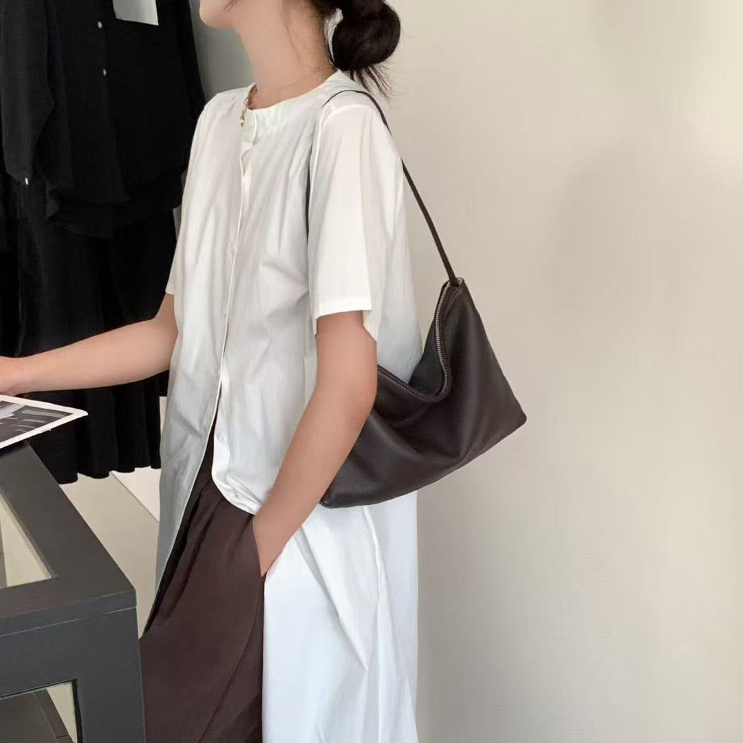 Dark brown hobo shoulder bag worn with a white outfit
