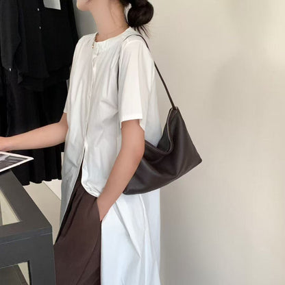 Dark brown hobo shoulder bag worn with a white outfit