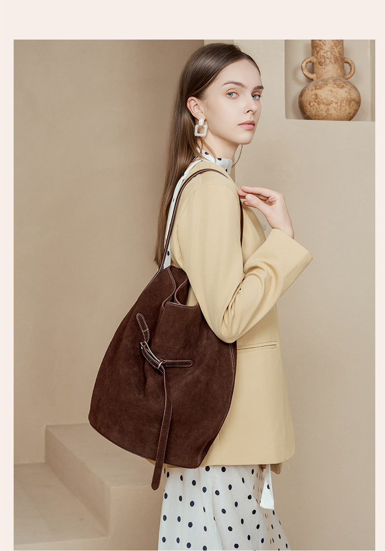 Dark brown suede tote shown from a side angle