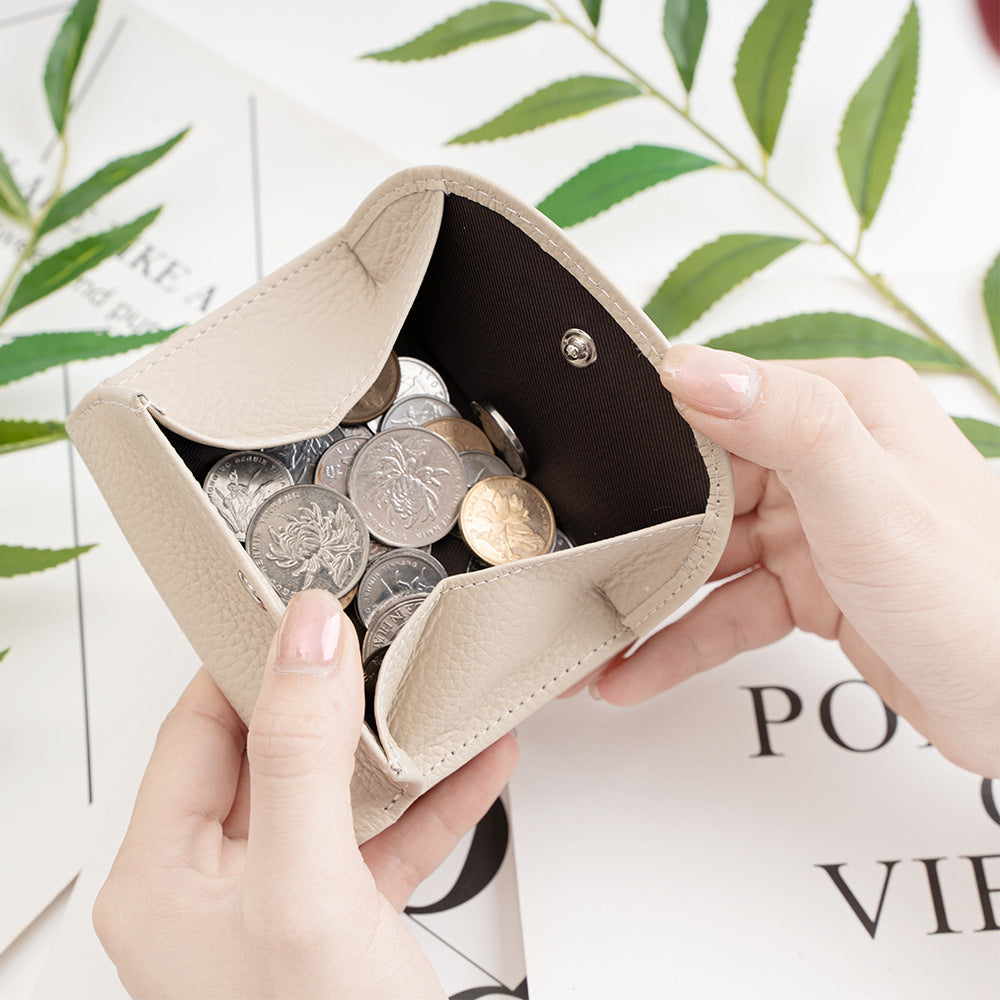 Wallet open showing coin pocket filled with coins