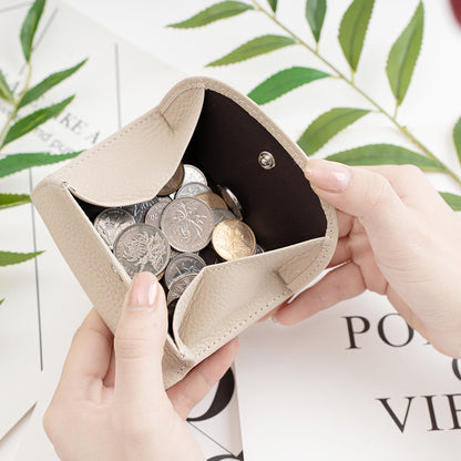 Wallet open showing coin pocket filled with coins
