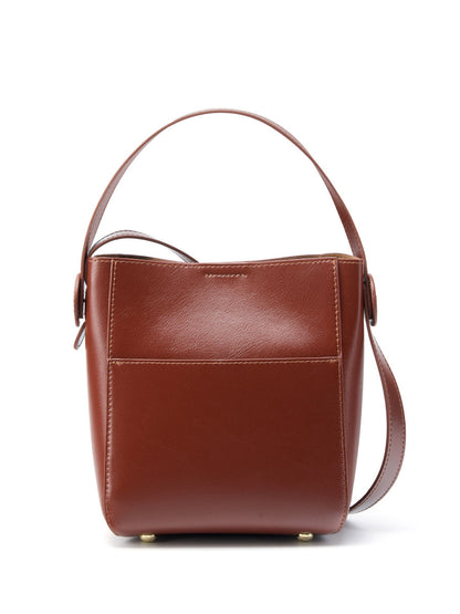 Back view of brown cowhide leather bucket bag on white background