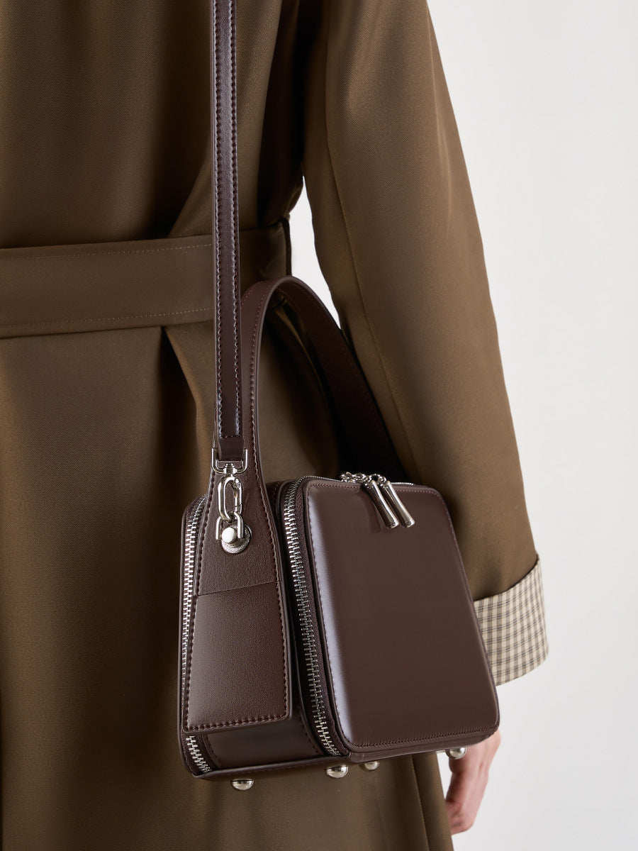 Crossbody view showing the detachable strap and side card pocket detail