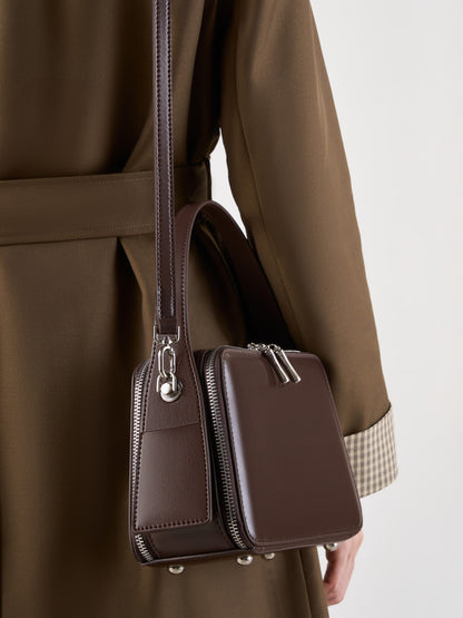 Crossbody view showing the detachable strap and side card pocket detail