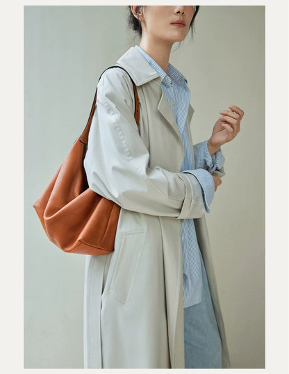 Caramel hobo bag worn over the shoulder in a full outfit view