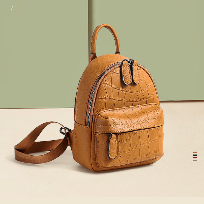 Tan crocodile-embossed leather backpack angled front view