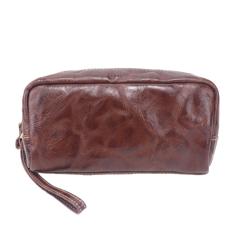 Chestnut leather cosmetic pouch featuring stitched edges