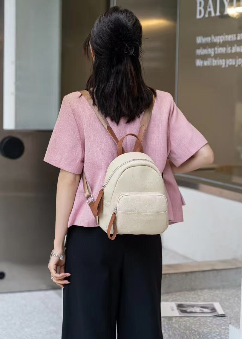Brown backpack shown from the back with shoulder straps