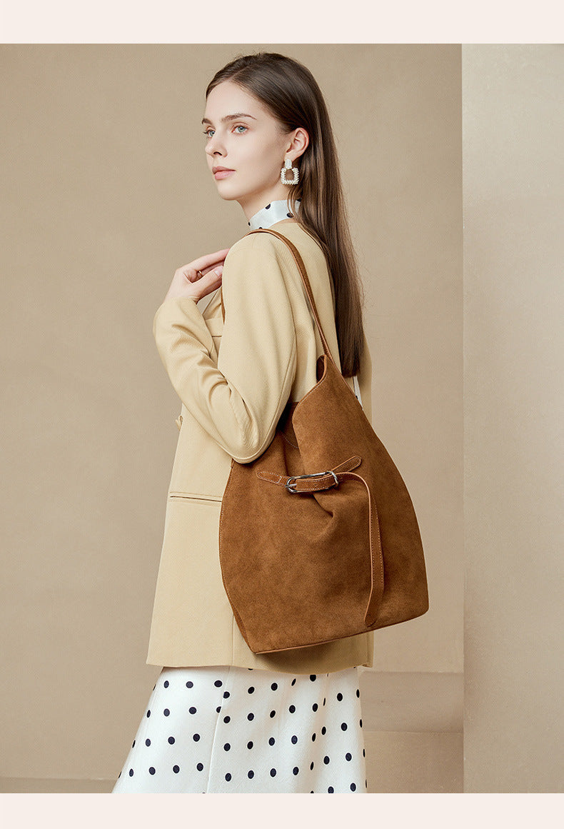 Close view of caramel suede tote and front belt detail
