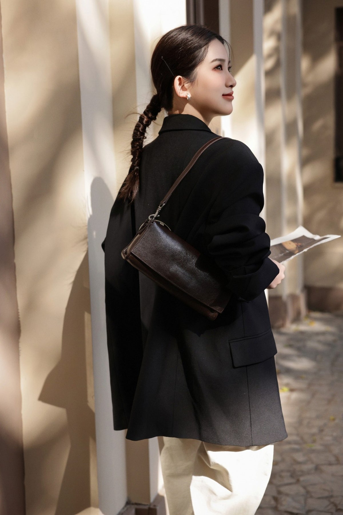 Coffee bag displayed against a dark outfit