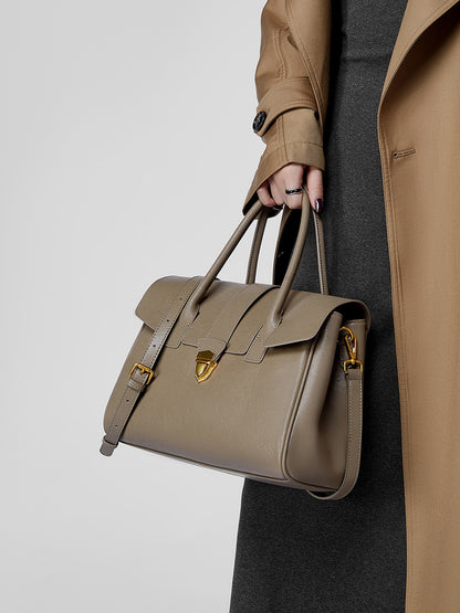 Top-grain cowhide satchel bag in taupe carried by top handles