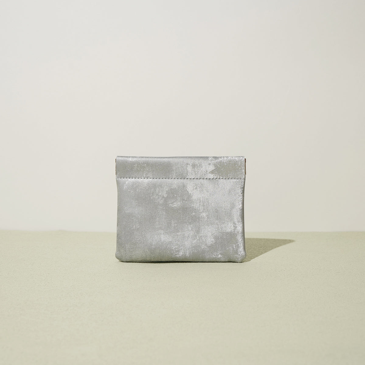 Silver metallic satin card pouch displayed upright