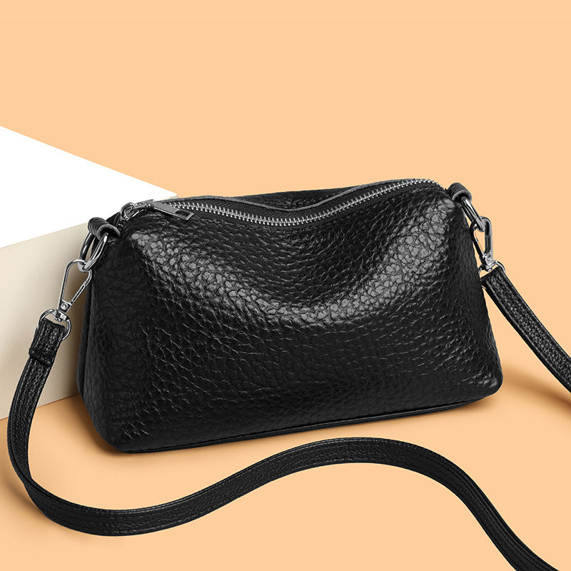 Black pebbled cowhide mini crossbody bag with zip top