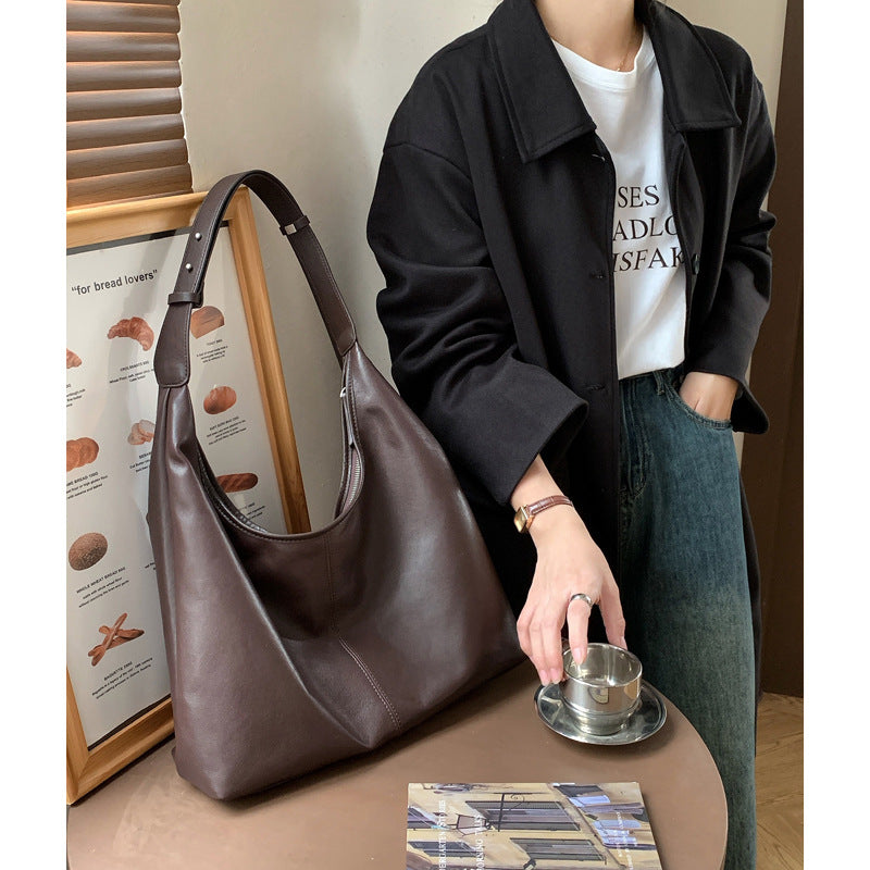 Ebony brown leather hobo tote shown beside a casual outfit