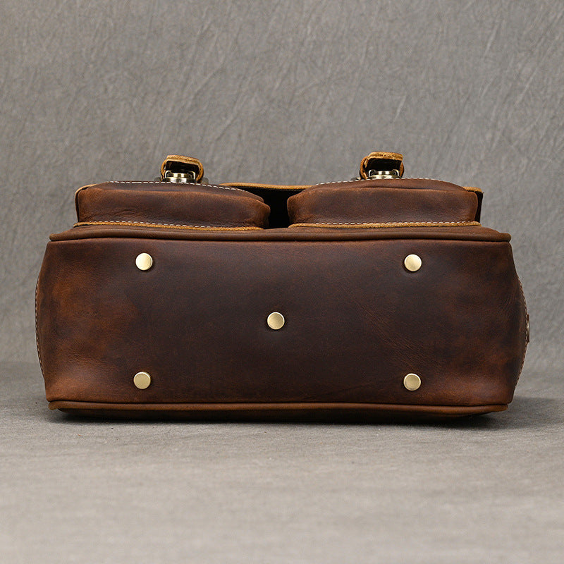 Base view of dark brown bag with metal feet