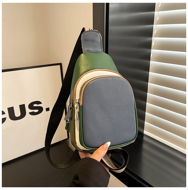 Textured blue and green sling bag displayed upright