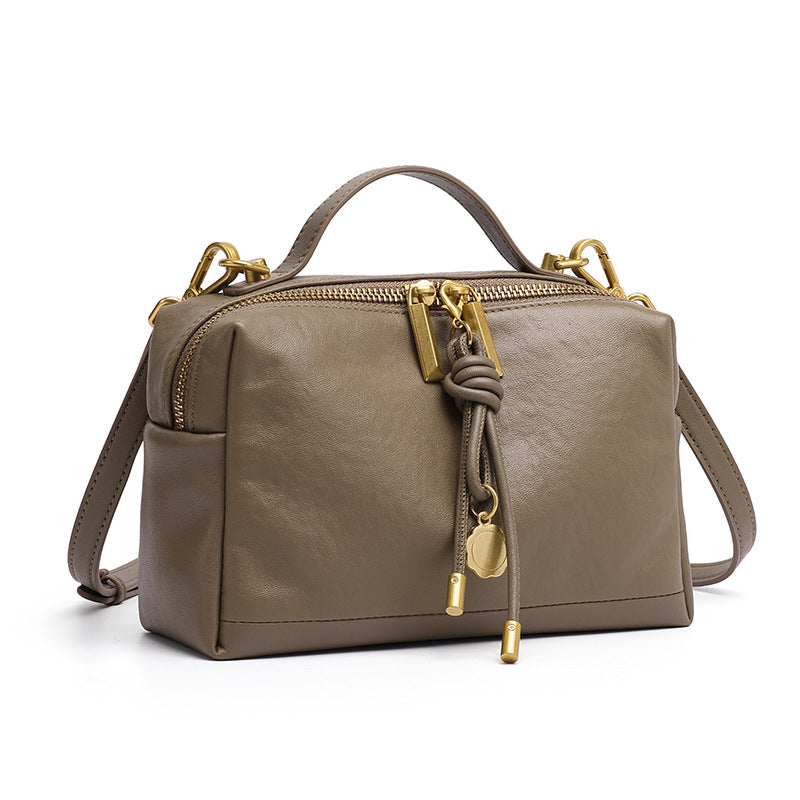 Gray cowhide leather pillow-shaped crossbody bag with knotted leather pull