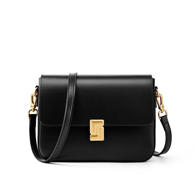Black cowhide leather crossbody bag with turn-lock closure on white background